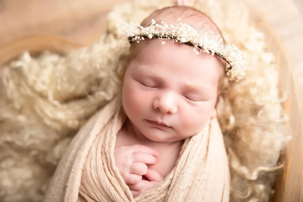 Keep the focus on the baby's face by using simple props
